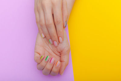 Close-up of woman hand with pink petals