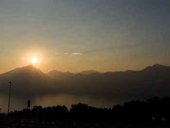 Scenic view of silhouette mountains against sky during sunset