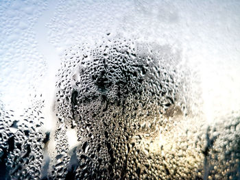 Close-up of raindrops on glass window