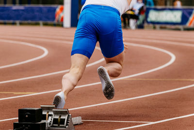 Athlete runner start from starting blocks to run sprint race