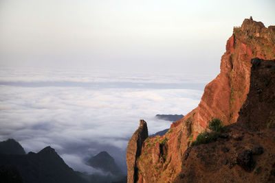 High section of cliff against cloudy sky