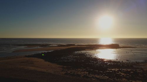 Scenic view of sea against clear sky during sunset