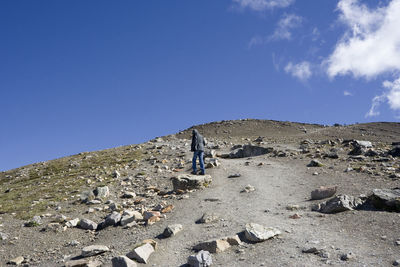 Low angle view of man on mountain against sky