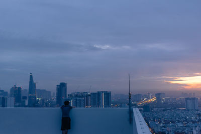 Modern buildings in city against cloudy sky