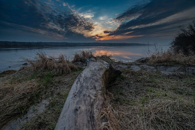 Scenic view of beach against sky during sunset