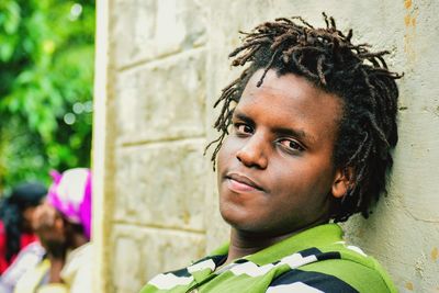 Portrait of young man against wall