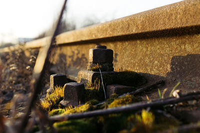 Close-up of rusty metal bridge against sky