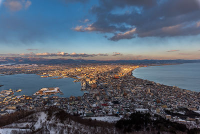 High angle view of townscape by sea against sky