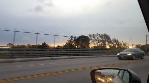 Cars on road against sky