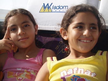 Close-up portrait of smiling girl with text