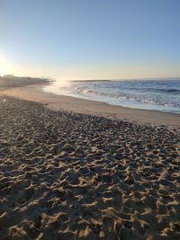 The beautiful light show between sea and sun at sunrise time on the coast in tuscany