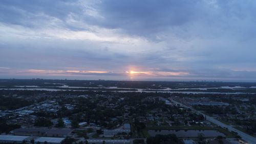 Aerial view of cityscape against sky at sunset