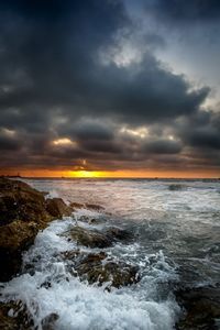 Scenic view of sea against cloudy sky