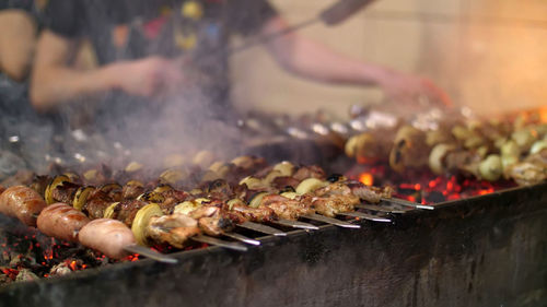 Grilled kebab cooking on metal skewer closeup. roasted meat cooked at barbecue. 