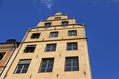 Low angle view of building against clear blue sky