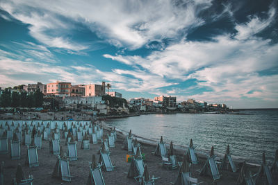 Panoramic view of sea and buildings against sky