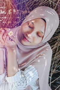 Portrait of a young woman with eyes closed