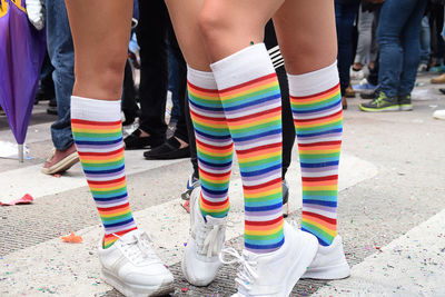 Low section of people wearing colorful socks while standing on street