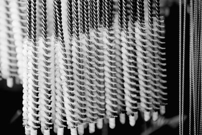 Close-up of brushes for sale at night