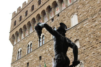 Low angle view of statue against sky