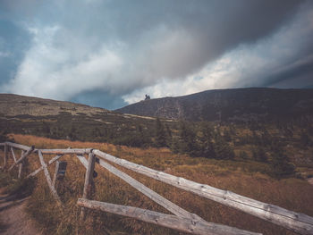 Road leading towards mountains against sky