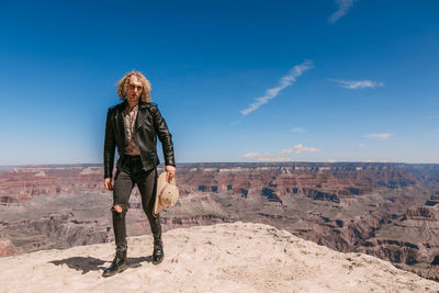 Man standing on desert against sky