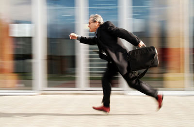 Full length of woman running in city