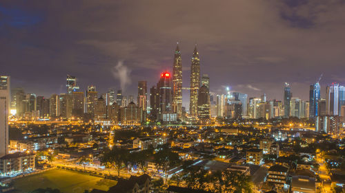 Aerial view of illuminated buildings in city at night
