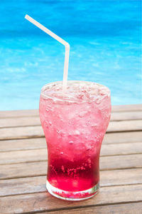 Close-up of drink on table at swimming pool