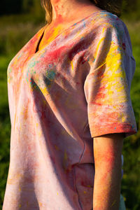 Cropped image of woman in t-shirt covered colourful holi powder paint.