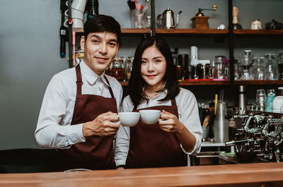 Portrait of young couple with coffee