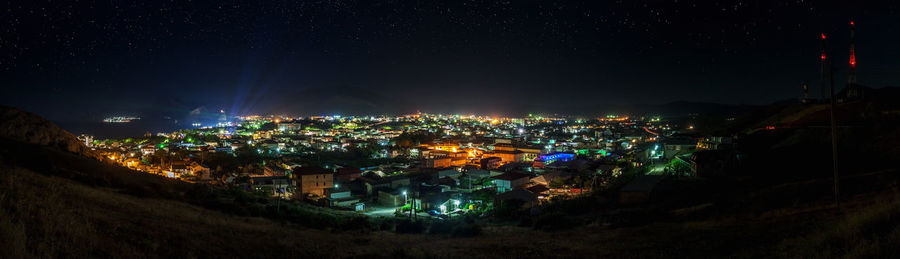 High angle view of illuminated buildings in city at night