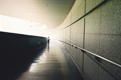 Empty footpath in illuminated tunnel