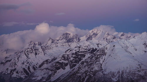 Scenic view of snow covered mountains against sky