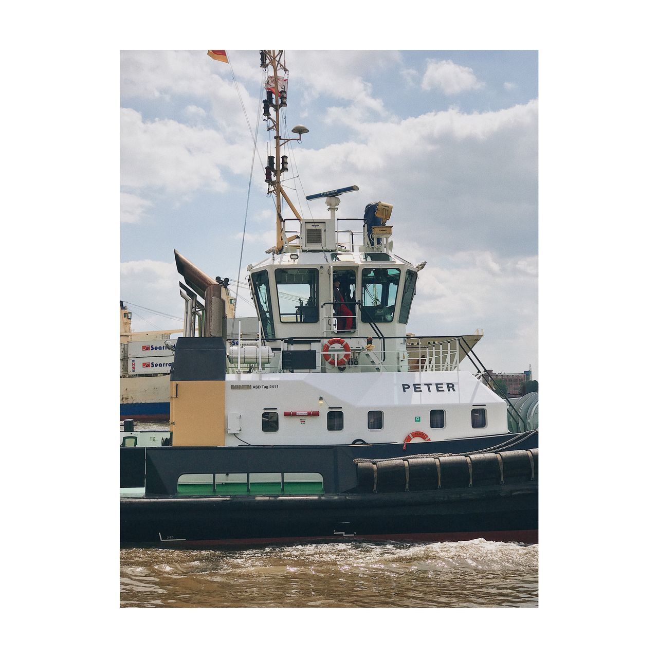 SHIP MOORED AT SEA SHORE AGAINST SKY