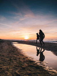 Silhouette of young couple on beach