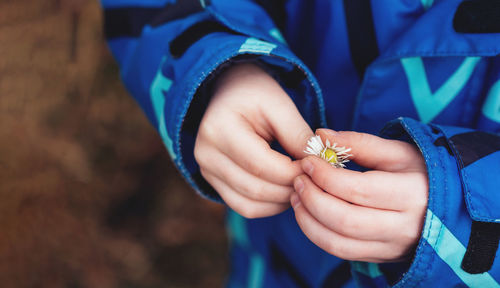 Close-up of hand holding small baby