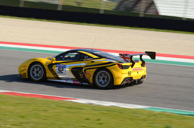 Blurred motion of yellow car on road