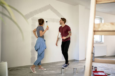 Side view of couple standing at home