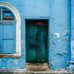 Closed blue door of old building