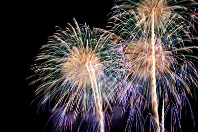 Low angle view of firework display at night