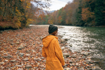 Man standing on rock during autumn