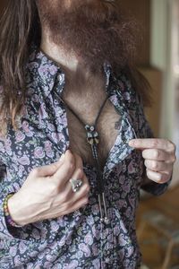 Young man showing off a necklace