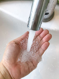 Close-up of hand holding water