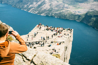 High angle view of people overlooking calm lake