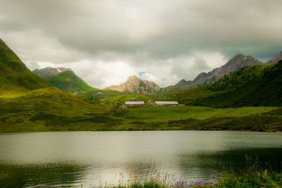 Scenic view of lake and mountains against sky