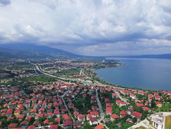 High angle view of townscape by sea against sky