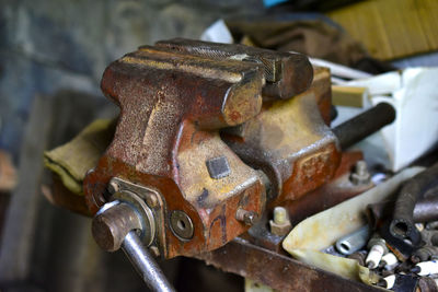 Red massive locksmith iron vise on an iron table