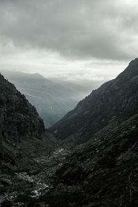 Idyllic shot of mountains against cloudy sky