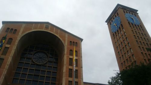 Low angle view of clock tower against sky